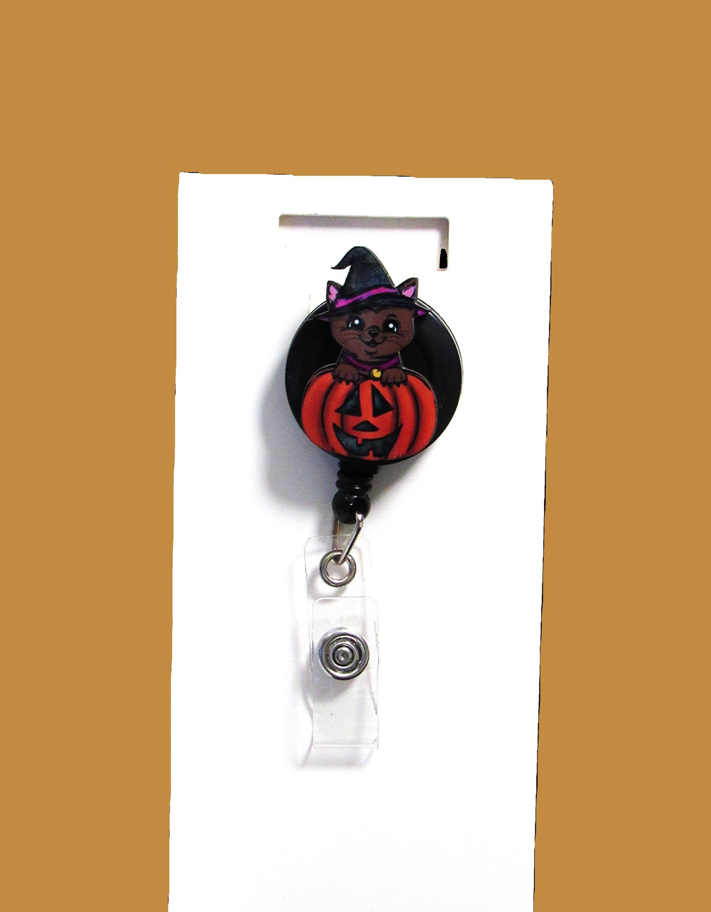 Witch Cat in a Pumpkin Shaped Sublimated Badge Reel